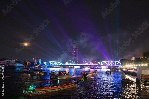 Memorial Bridge, and Phra Pok Klao Bridge with buildings and Chao Phraya River at night. Urban city, Downtown Bangkok, Thailand. photo