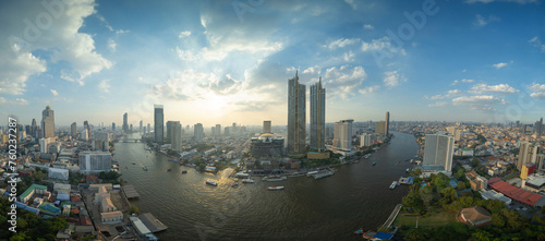 Aerial view of boats and Taksin Bridge with Chao Phraya River, Bangkok Downtown. Thailand. Financial district and business centers in smart urban city. Skyscraper and high-rise buildings. photo