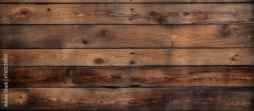 A closeup shot showcasing a beautiful brown hardwood plank wall, with a blurred background. The wood stain highlights the intricate pattern of the wooden rectangles