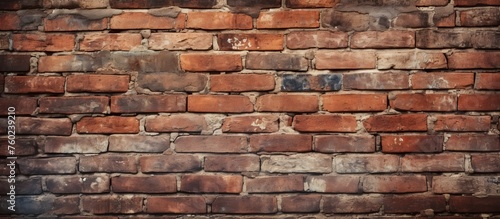 A detailed closeup of a brown brick wall showcasing the rectangular shape of the individual bricks. The brickwork is a composite building material commonly used in stone walls