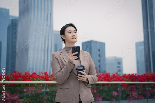 Businesswoman Using Smartphone During Coffee Break