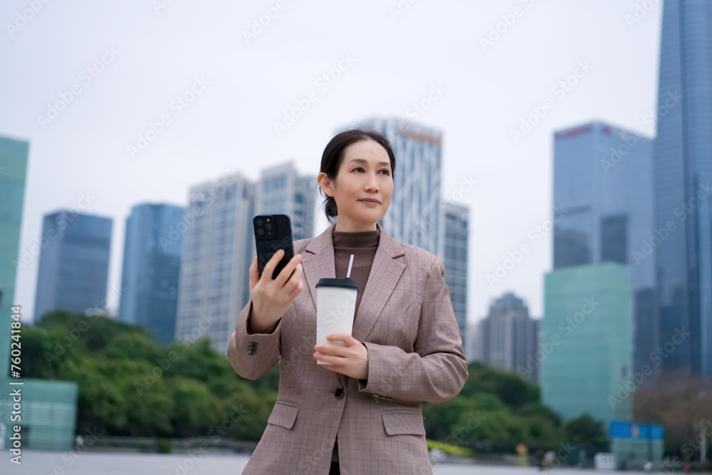 Professional Woman with Smartphone and Coffee in City Professional Woman with Smartphone and Coffee in City