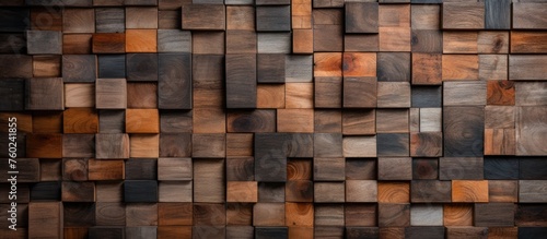 Close up of a brown hardwood wall comprised of rectangular wooden squares  creating a unique and intricate pattern. The wood stain enhances the natural beauty of the building material