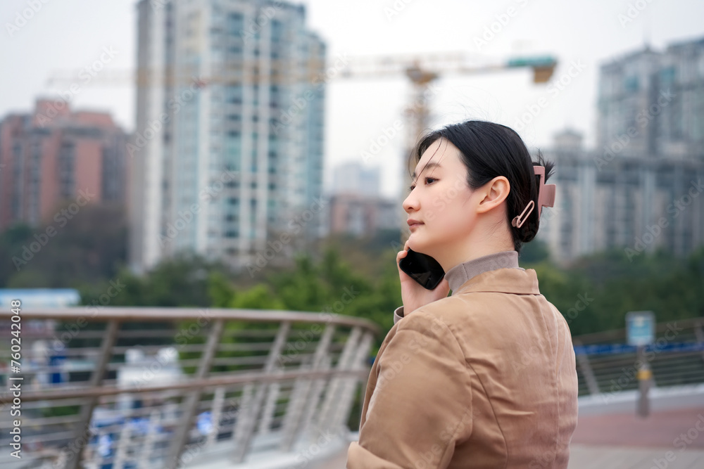 Young Woman Reflecting in Urban Setting with Cranes
