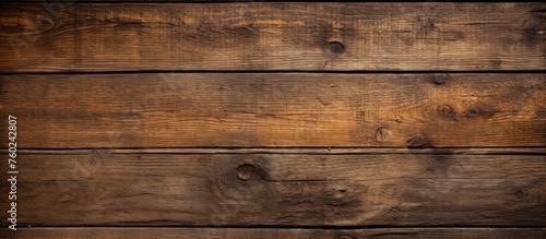An artistic close up of a brown hardwood wall, showcasing a beautiful wood stain pattern on rectangular planks, resembling a painting