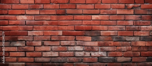 A detailed closeup of a brown brick wall showcasing the rectangular pattern formed by the composite material. Tints and shades add depth to the building material, with windows adding contrast