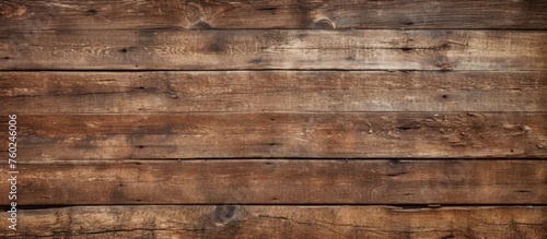 A closeup shot showcasing the intricate pattern of brown hardwood flooring, featuring rectangular planks with a wood stain on a beige plywood background