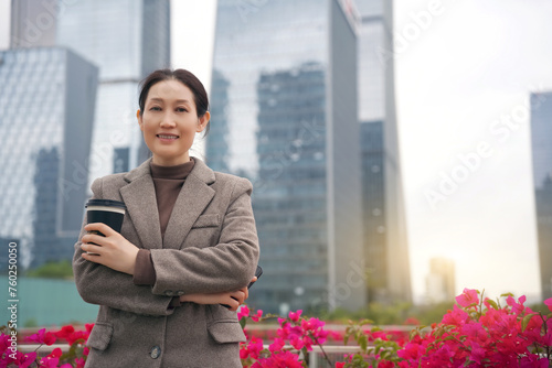 Confident Businesswoman with Coffee in Urban Setting