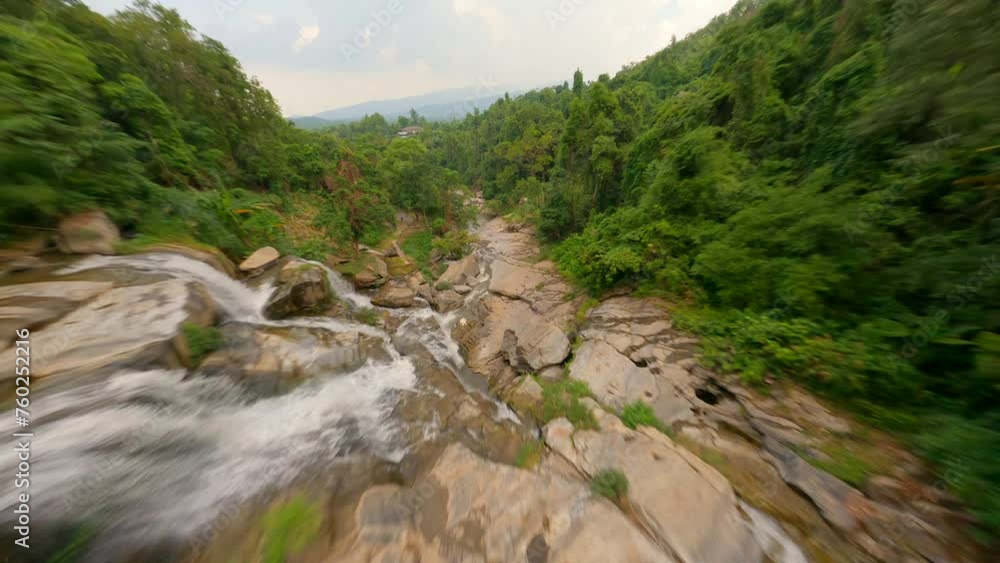 Dynamic FPV flight over tropical waterfall in Chiang Mai in Thailand Dynamic FPV flight over tropical waterfall in Chiang Mai in Thailand