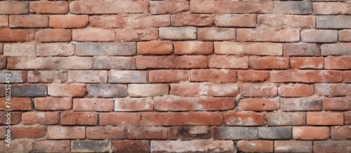 A detailed closeup of a brown brick wall showcasing the intricate brickwork done by a skilled bricklayer. The rectangular bricks are held together by mortar  creating a sturdy composite material