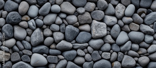 A stack of rocks can be a creative flooring or road surface using cobblestone. The composite material can create a pattern, with electric blue metal accents for a unique building material