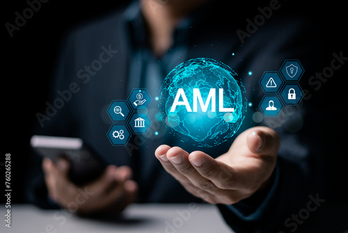 AML, Anti money laundering financial bank concept. Businessman holding globe with AML icon on virtual screen for anti money laundering regulations. photo