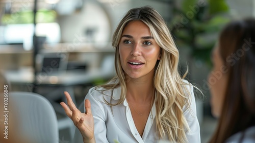 Young business woman talking with a colleague in her office