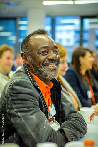 A group of adult learners engaged in a seminar, exchanging ideas and insights as they strive to expand their knowledge in a professional development setting.