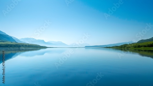 Serene Lake Reflecting a Clear Blue Sky and Distant Mountains in Peaceful Tranquility