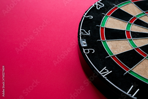 target dart board on the red table background, center point, head to target marketing and business success concept