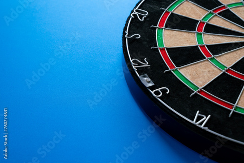 target dart board on the blue table background, center point, head to target marketing and business success concept