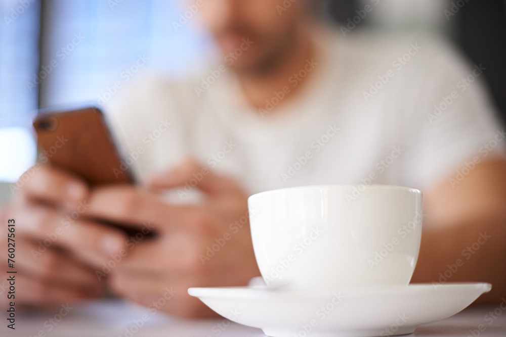 Man, cup and hands for phone in coffee shop, communication and website for information. Male person, closeup and app for conversation, social media and remote work in restaurant for research by latte Man, cup and hands for phone in coffee shop, communication and website for information. Male person, closeup and app for conversation, social media and remote work in restaurant for research by latte