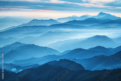 a view of a mountain range with a few clouds © WapTock