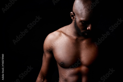 Black man, muscle and fitness with shadow for exercise or workout on a dark studio background. Closeup of young African male person or bodybuilder with masculine or muscular body on mockup space
