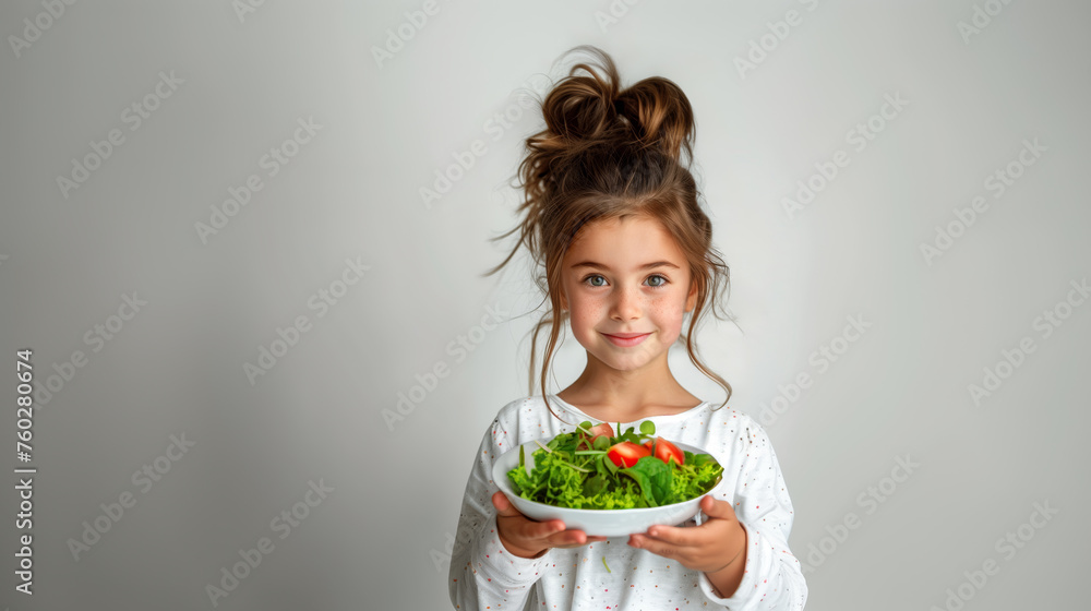 A young child holding a bowl of salad, photograph on a light background. Healthy lifestyle concept. Generative AI A young child holding a bowl of salad, photograph on a light background. Healthy lifestyle concept. Generative AI