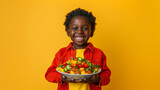 Smiling child holding a bowl of salad on a yellow background. Photography and nutrition concept. Generative AI