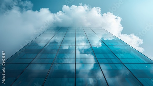 A glass building with clouds reflecting on it symbolises the idea of cloud computing and digital technology.