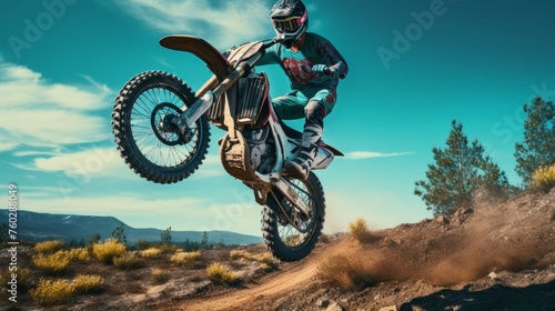 motorcycle stunt or car jump, A off road moto cross type motor bike in mid air during a jump with a dirt trail photo