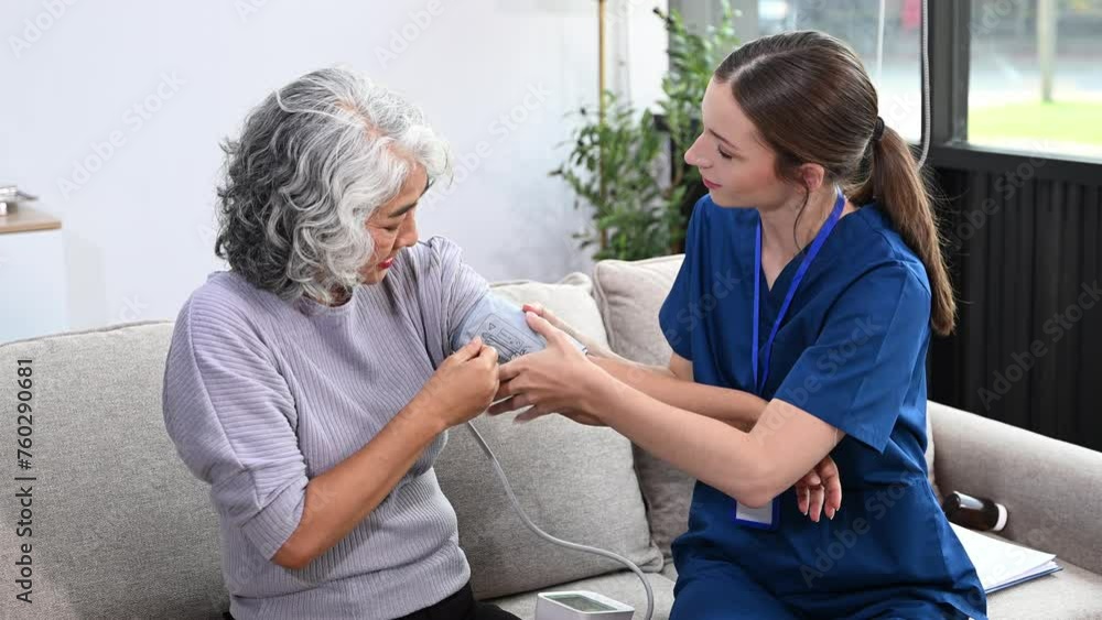 Young nurse helping elderly woman walk in the room, holding his hand, supporting. Treatment and rehabilitation after injury in assisted living senior care .. Young nurse helping elderly woman walk in the room, holding his hand, supporting. Treatment and rehabilitation after injury in assisted living senior care ..