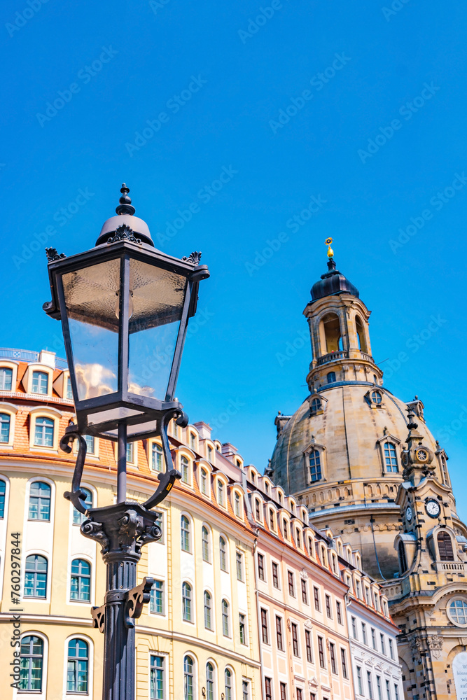 Dresden, Germany. Church of our Lady at Neumarkt square in downtown of Dresden at sunny summer day with blue gradient sky and old street light Dresden, Germany. Church of our Lady at Neumarkt square in downtown of Dresden at sunny summer day with blue gradient sky and old street light