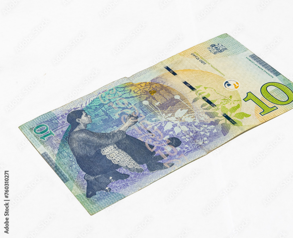 Ten  Lari banknote of the National Bank of Georgia on a white background