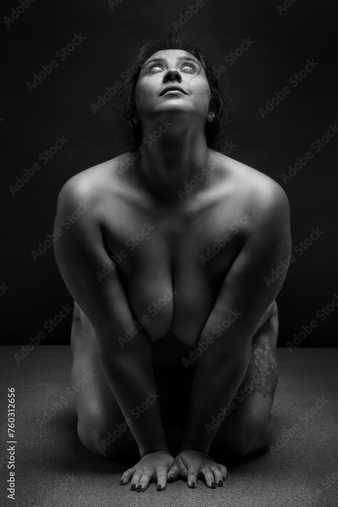 Fototapeta premium Obese nude woman doing yoga exercise. Workout concept. 