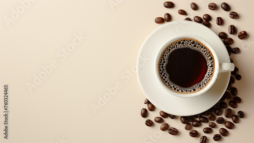 Brown coffee beans beside a white cup filled with steaming black coffee for a morning caffeine boost
