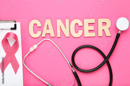 Ribbon with clipboard, stethoscope and word Cancer on pink background