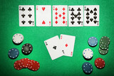 Poker chips and cards on green table
