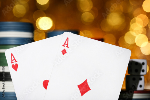 Poker chips and cards on blurred bokeh background