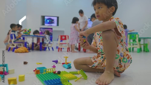 Adorable little boy and girl enjoying play toy block building imagin education learnning photo