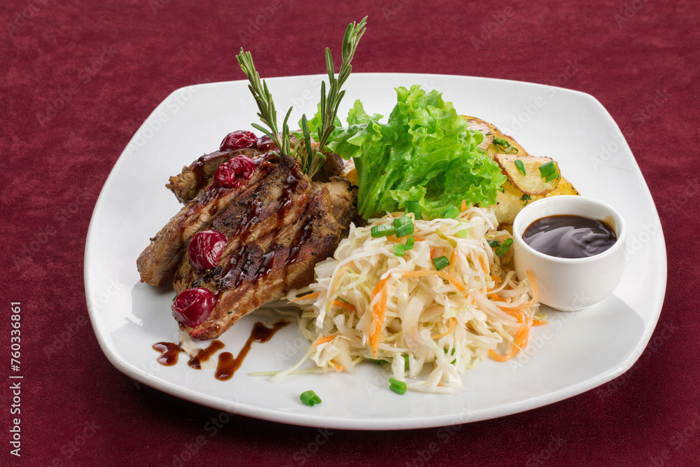 Meat steak with side dish on a white plate, restaurant menu