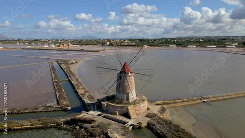 Windmills at the Salt Pans near Marsala at Sicily, Italy in Europe. colorful windmills at the saltpans of Sicily in summer photo
