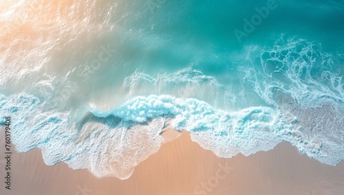 Aerial shot of a gentle turquoise ocean meeting a sandy beach with soft waves, evoking a serene, tranquil vibe perfect for summer or travel themes.