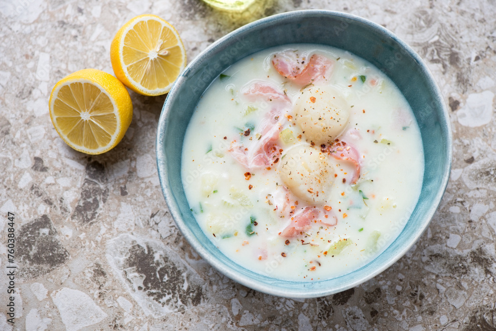 Green bowl with scallop chowder on a light-brown granite background, horizontal shot, high angle view Green bowl with scallop chowder on a light-brown granite background, horizontal shot, high angle view