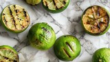 Grilled lime halves on marble background. Top view food photography.