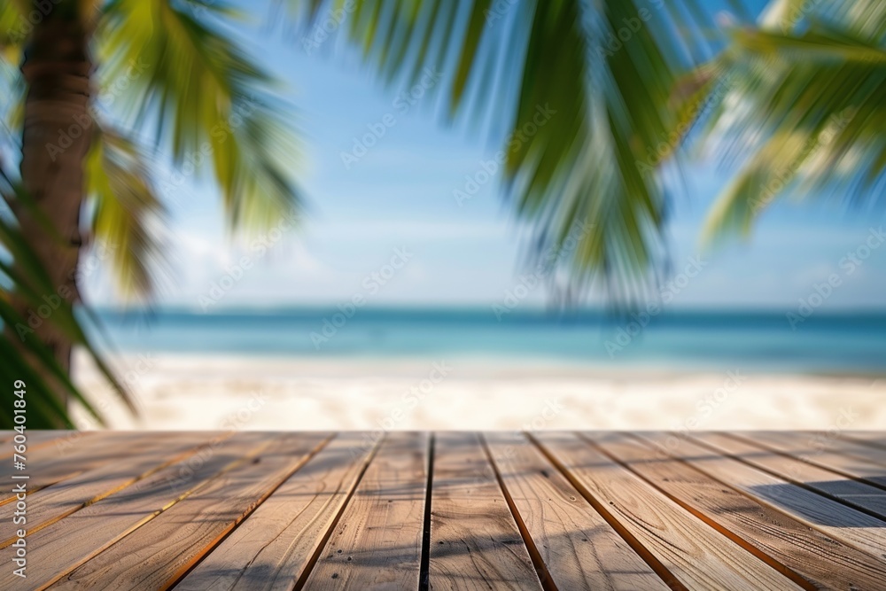 Wooden table with blurred bokeh light seascape and palm leaves at tropical beach background Wooden table with blurred bokeh light seascape and palm leaves at tropical beach background
