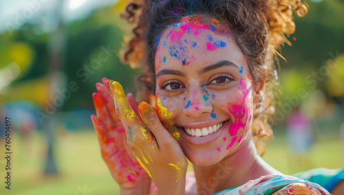 Portrait of happy young indian woman with holi powder on her face.