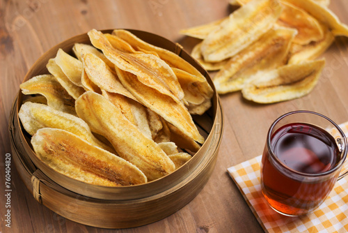 Crispy Banana chips or Keripik pisang in indonesia, served in bamboo bowl on the table photo