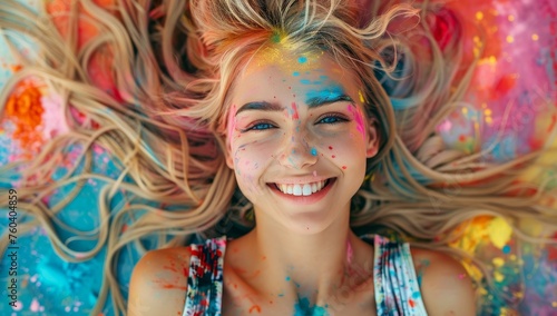 Young woman covered in colorful powder celebrating Holi festival.