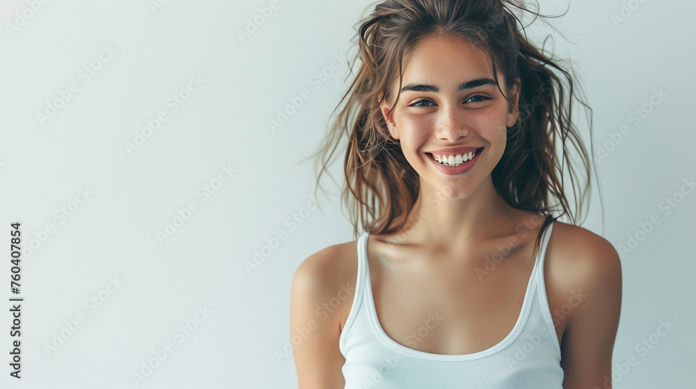 Beautiful young sexy caucasian woman with a fashion hairstyle and subtle smile, wearing a white sleeveless top, exuding a sophisticated charm.