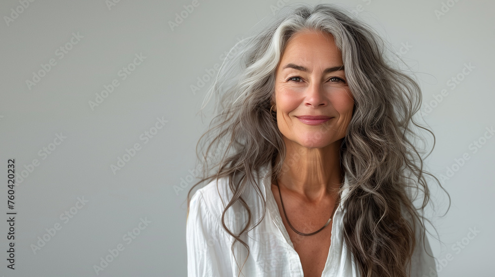 Portrait of a confident senior woman with elegant white hair and a warm smile, wearing a white shirt, embodying timeless beauty and sophistication. Portrait of a confident senior woman with elegant white hair and a warm smile, wearing a white shirt, embodying timeless beauty and sophistication.