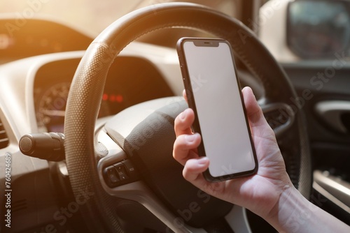 hand holding a phone on car