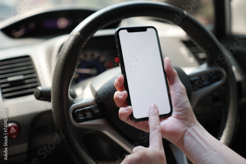 person driving car, using phone on car © komthong wongsangiam